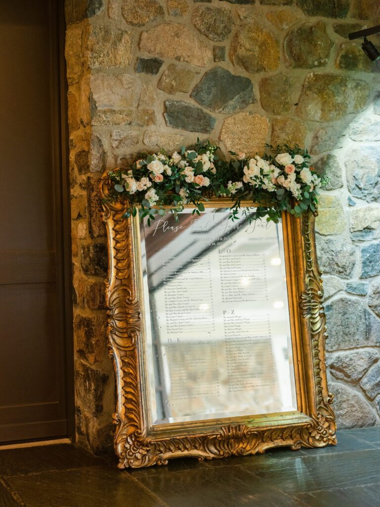 Seating chart on mirror with gold frame for New Jersey Wedding