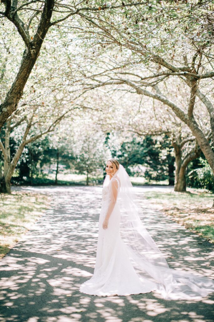 Outdoor bridal portrait before Rumson Country Club River House Wedding