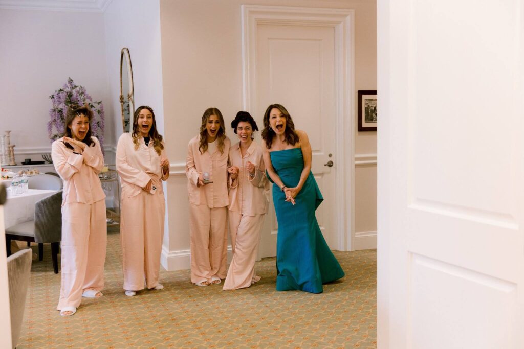 Bridesmaids and mom emotional reaction to seeing bride for the first time