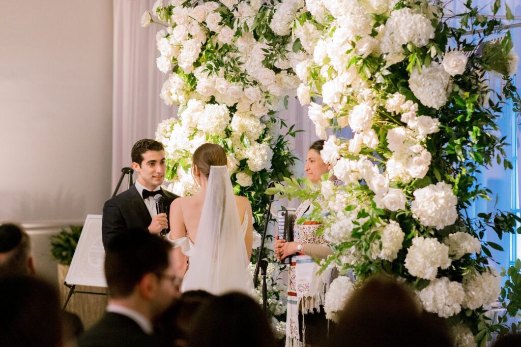 Wedding ceremony at the Alpine Country Club with gorgeous floral arch 