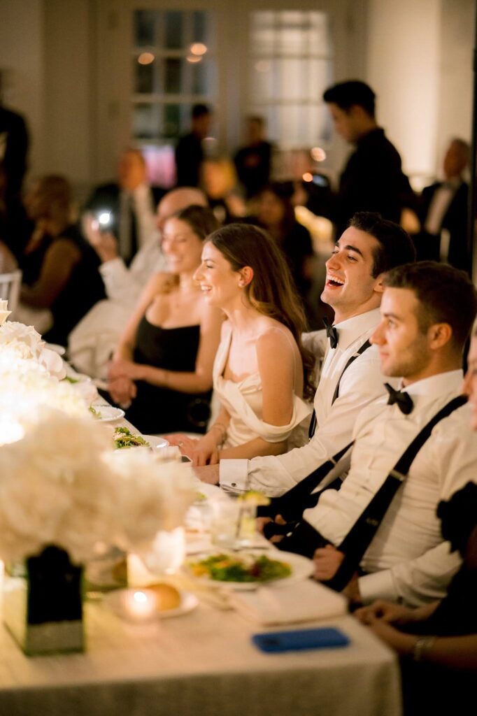 Bride and groom reaction to speeches during wedding reception